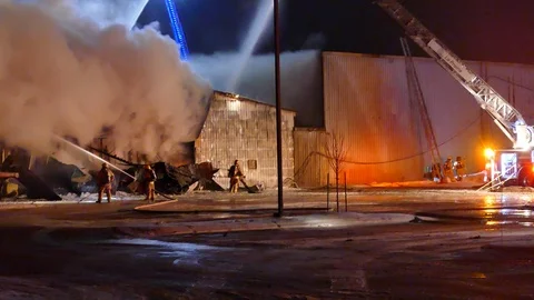 Firemen trying to remove sheet metal Video stock 103630095