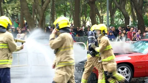 Firemen Turn off the fire solving a car accident fire in the road street. Stock Footage 78569181