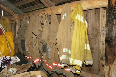 Firemen uniforms hanging up Foto stock