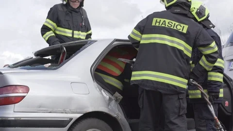 Firemen using hydraulic cutter tool to cut off the roof of the crashed car Stock Footage 113616700