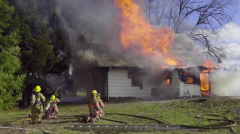 Firemen watch burning house Stock Footage 60985451