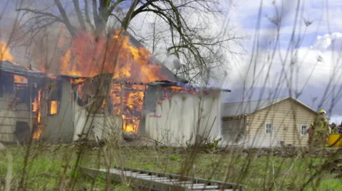 Firemen watch home on fire Stock Footage 61176818