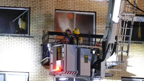 Firemen watering fire Stock Footage 114751986