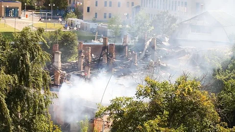 Firemen work on a very smoky object Stock Footage 80021550