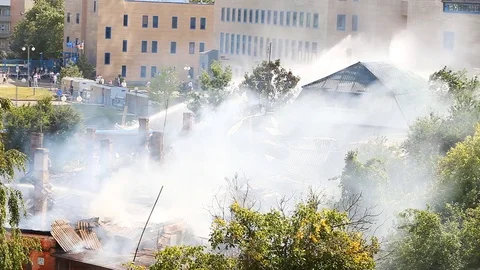 Firemen work on a very smoky object Stock Footage 80258336