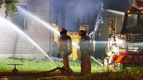 Firemen working on active house fire Stock Footage 114742946