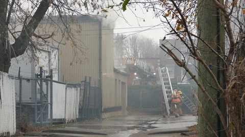 Firemen working in the alley Stock Footage 120119695