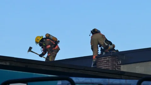 Firemen working with ax Stock Footage 119865657