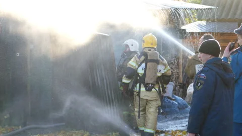 Firemen working at burning house Stock Footage 94972084