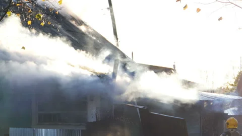 Firemen working at burning house Stock Footage 98430702