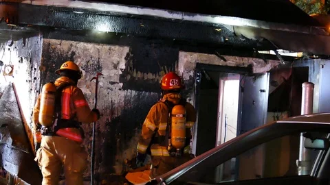 Firemen working on commercial fire Stock Footage 115968473