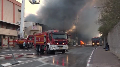Firemen working on a fire in Israel resulting of a Gaza rocket attack Stock Footage 145867145