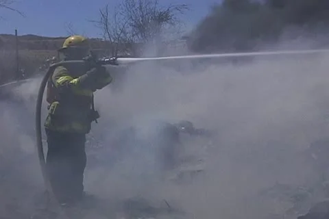 Firemen working on recycling facility fire 006 Stock Footage 16014215