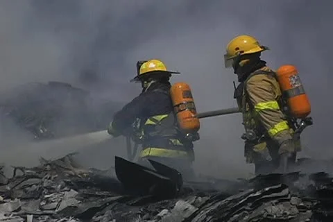 Firemen working on recycling facility fire 007 Stock Footage 16015835