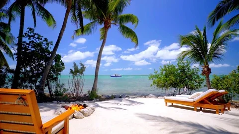 Firepit and Beach Chairs on White Sand Beach Tracking Shot Stock Footage 74398826