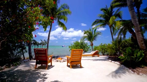 Firepit and Beach Chairs on White Sand Beach Tracking Shot Stock Footage 74398831