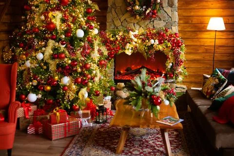 Fireplace and Christmas tree background. Festive interior inside wooden house Stock Photos