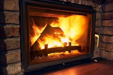 Fireplace and fire close view as object or background, brick wall Stock Photos
