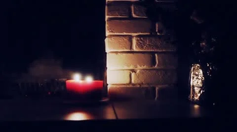 On the fireplace are four candles. in the background, half extinguished ember Stock Footage 12012735