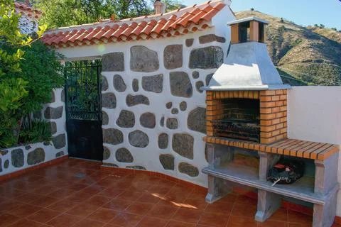 Fireplace on the backyard. Open summer barbeque kitchen with  grill. Photos