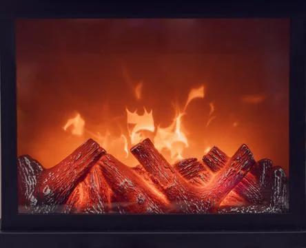 Fireplace with bright flames. Artificial decorative fireplace with imitation of Stock Photos