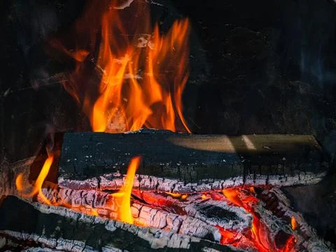 Fireplace with burning firewood as a concept for relaxing Stock Photos