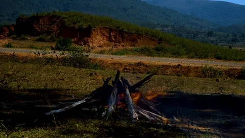 Fireplace daytime winter closeup fire sticks mountains Stock Footage 98732917