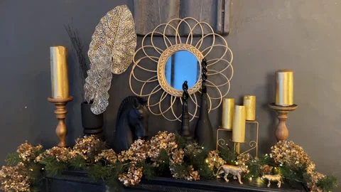 Fireplace with decorations, mirror, candles, statue of horse in black interior Stock Footage 225516244