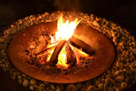 Fireplace with fire inside ancient external round bottom. Stock Photos