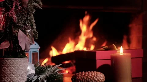 Fireplace with flame table artificial Christmas tree gift red box and candle Video stock 142558167