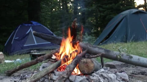 Fireplace in the forest, with the camp in the background. Stock Footage 57177840