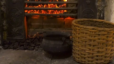 Fireplace in an old stone house with kitchen tools Stock Footage 85243052