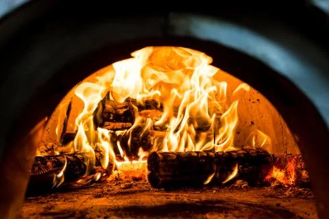 Fireplace with red hot fire Stock Photos