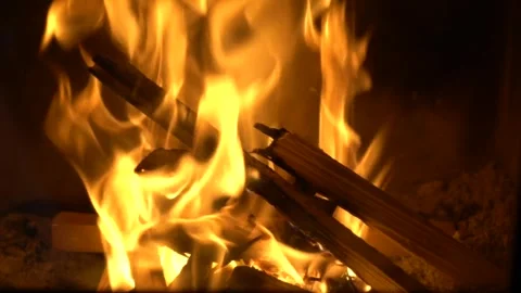 Fireplace slow motion, flames over wooden logs close up, cozy fire close up Stock Footage 256480672