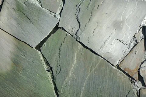 Fireplace wall made of irregularly shaped stone Stock Photos