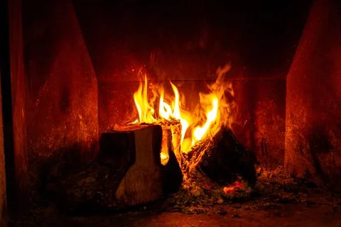 Fireplace with wood burning in winter Stock Photos