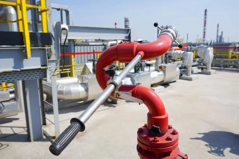 Fireplug to put out a fire against the background of an installation at an oi Stock Photos