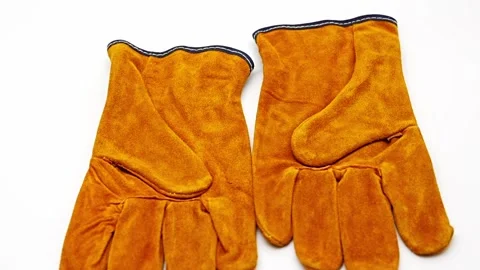 Fireproof gloves for safe handling in kitchen or workshop settings Video stock 329969796