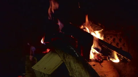 Fires burn in a fireplace with logs and embers during a winter evening at a Stock Footage 344321410