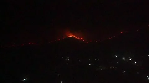 Fires to devour forests across the slopes of the mountain hill Stock Footage 297878344
