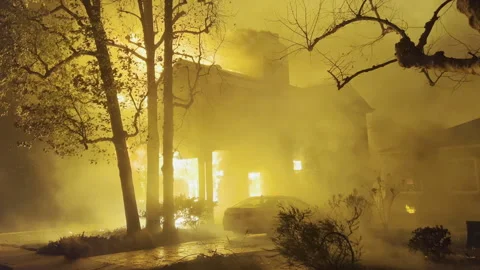Firestorm consuming a House, heavy winds spreading fires night in Los Angeles Stockbeeldmateriaal 302789018