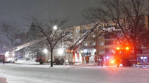 Firetruck during snowfall at night during in apartment place Stock Footage 125422095