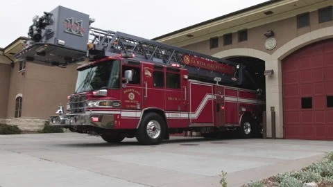 Firetruck pulls out of station to respond to call in San Diego Stock Footage