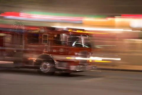Firetruck streaks by to attend emergency Stock Photos