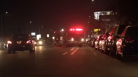 Firetruck On Street Blocking Road With Light On And Cars Driving Past. Video stock 87635962