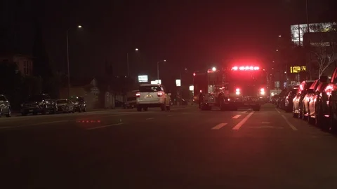 Firetruck On Street Blocking Road With Light On And Cars Driving Past. Video stock 87635981