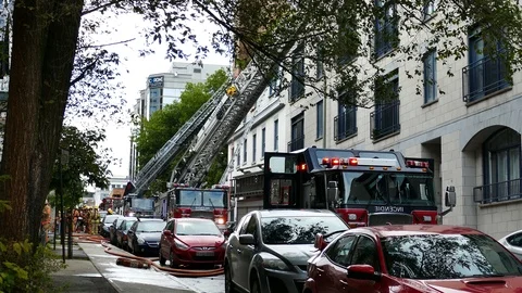 Firetrucks with erected ladders downtown Stockbeeldmateriaal 116713448