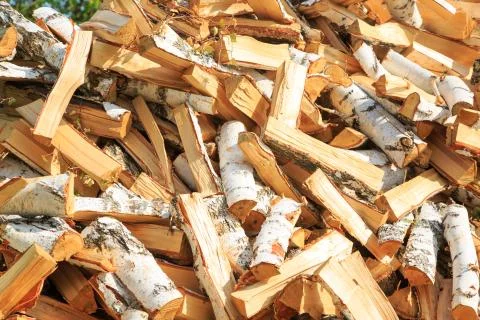 Firewood background - chopped firewood on a stack. Stock Photos