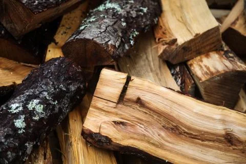 Firewood background - chopped firewood on a stack. Stock Photos
