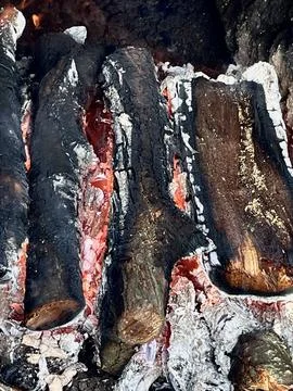 Firewood burning in a fire Stock Photos